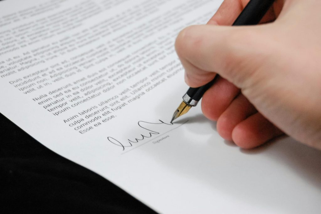 document-agreement-documents-sign-48148-48148 Close-up of a hand signing a legal document with a fountain pen, symbolizing signature and agreement.
